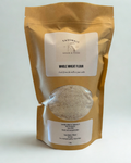 Package of whole wheat flour with a visible brand label on a white background